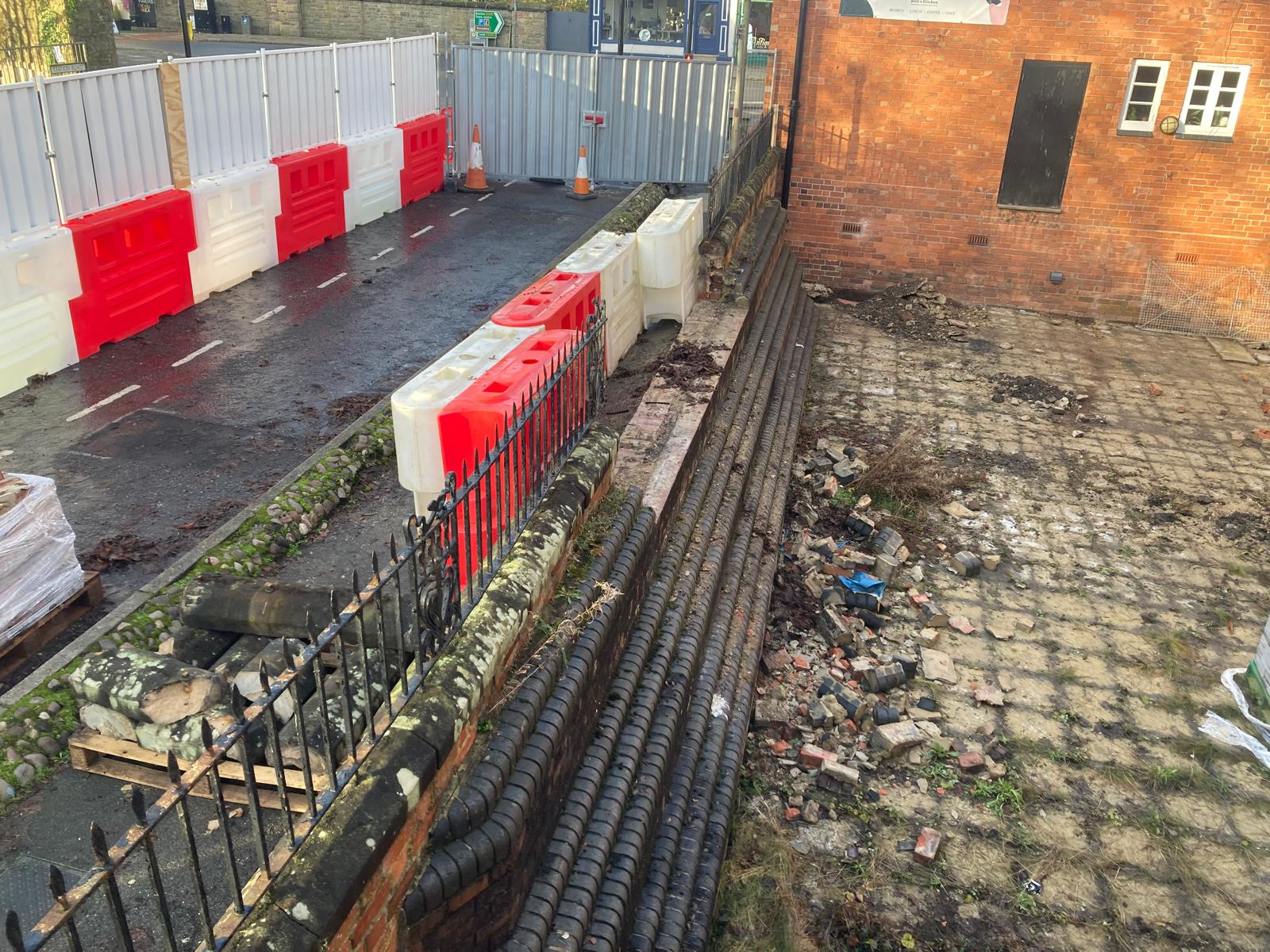 The wall and railings at the side of Ashbourne Methodist Church with a gap cut in it - this will be the new main entrance into The Link Centre.