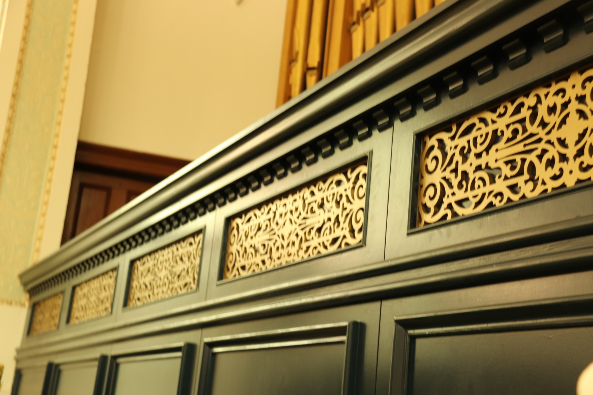 In Trinity Hall the detail and fretwork is completed on the new panelling below the organ 