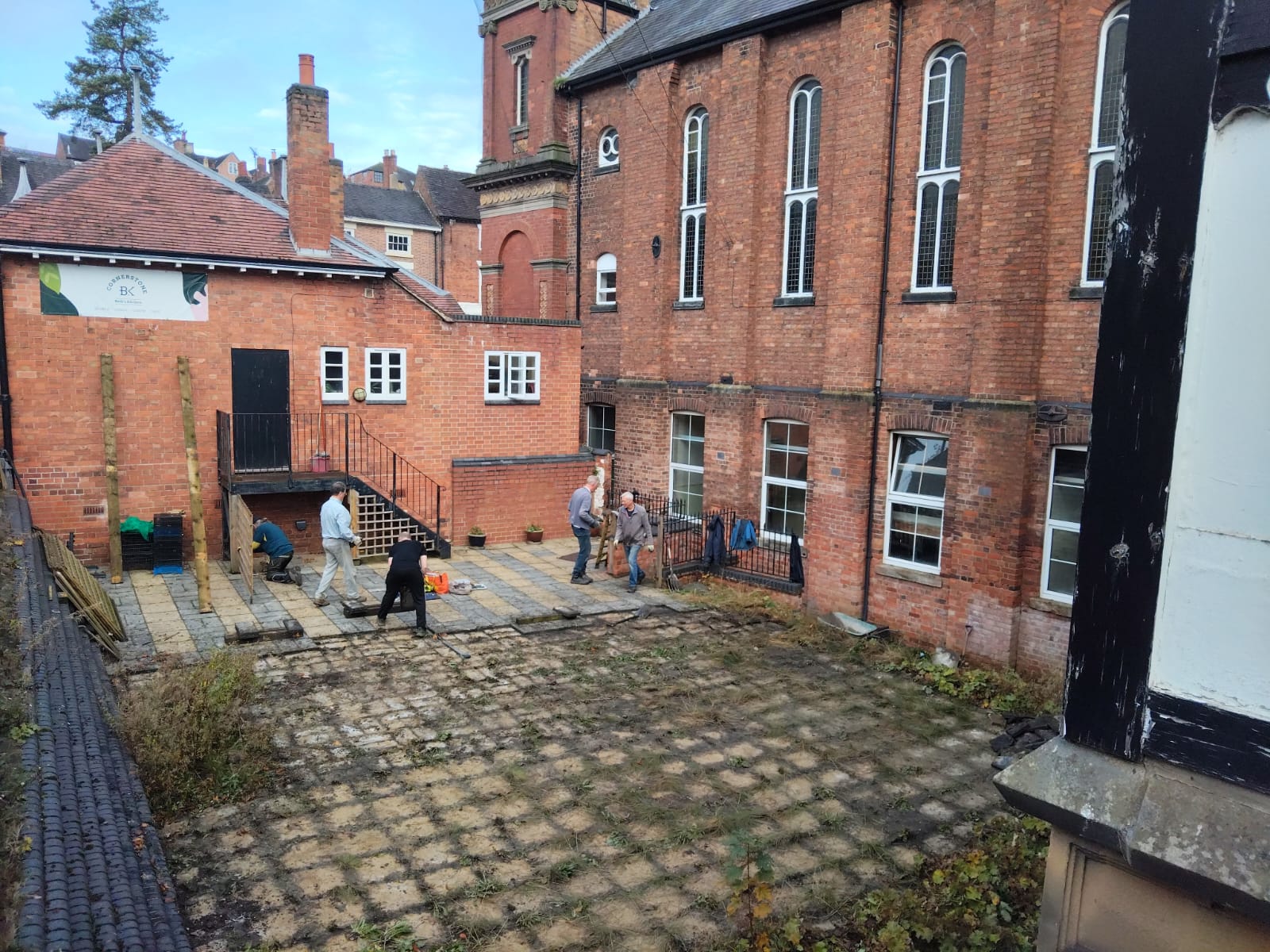 Volunteers lifting paving slabs outside Ashbourne Methodist Church, ready for groundworks to begin for The Link community hub.