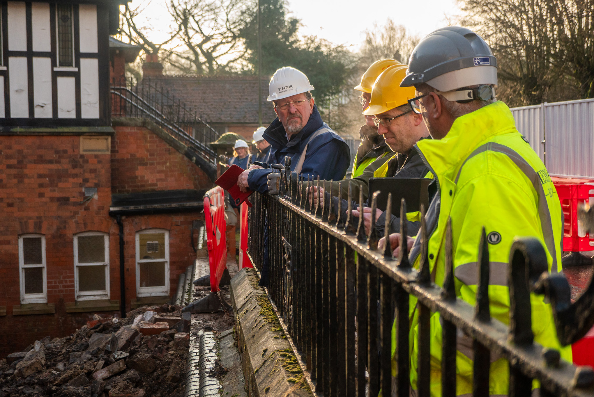 People wearing high vis jackets and safety hats during a site visit to the building works at Ashbourne Methodist Church