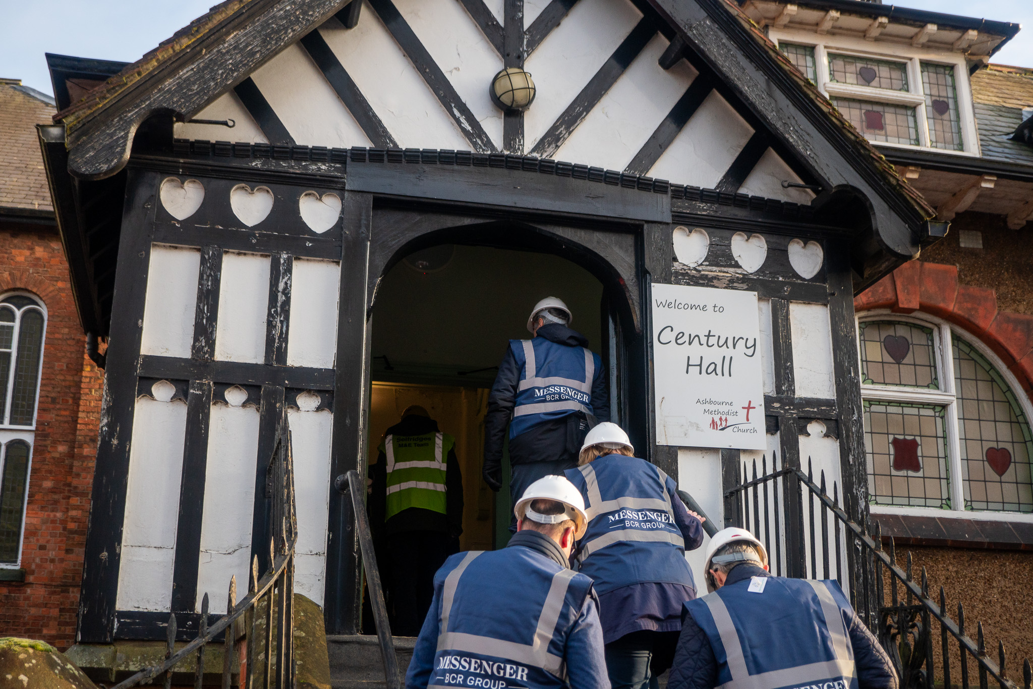 People wearing high vis jackets and safety hats during a site visit to the building works at Ashbourne Methodist Church