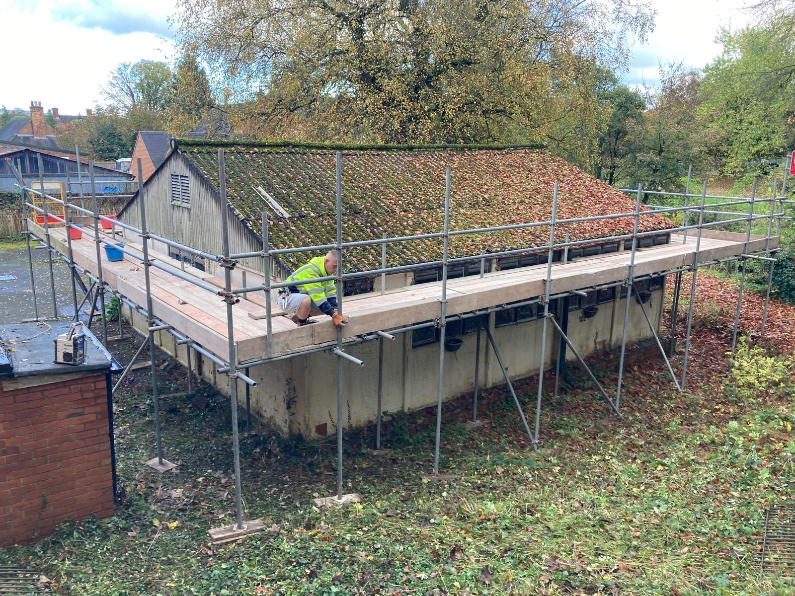 Scaffolding being erected at Ashbourne Methodist Church to enable the process of dismantling the prefab building from the rear of the church to begin